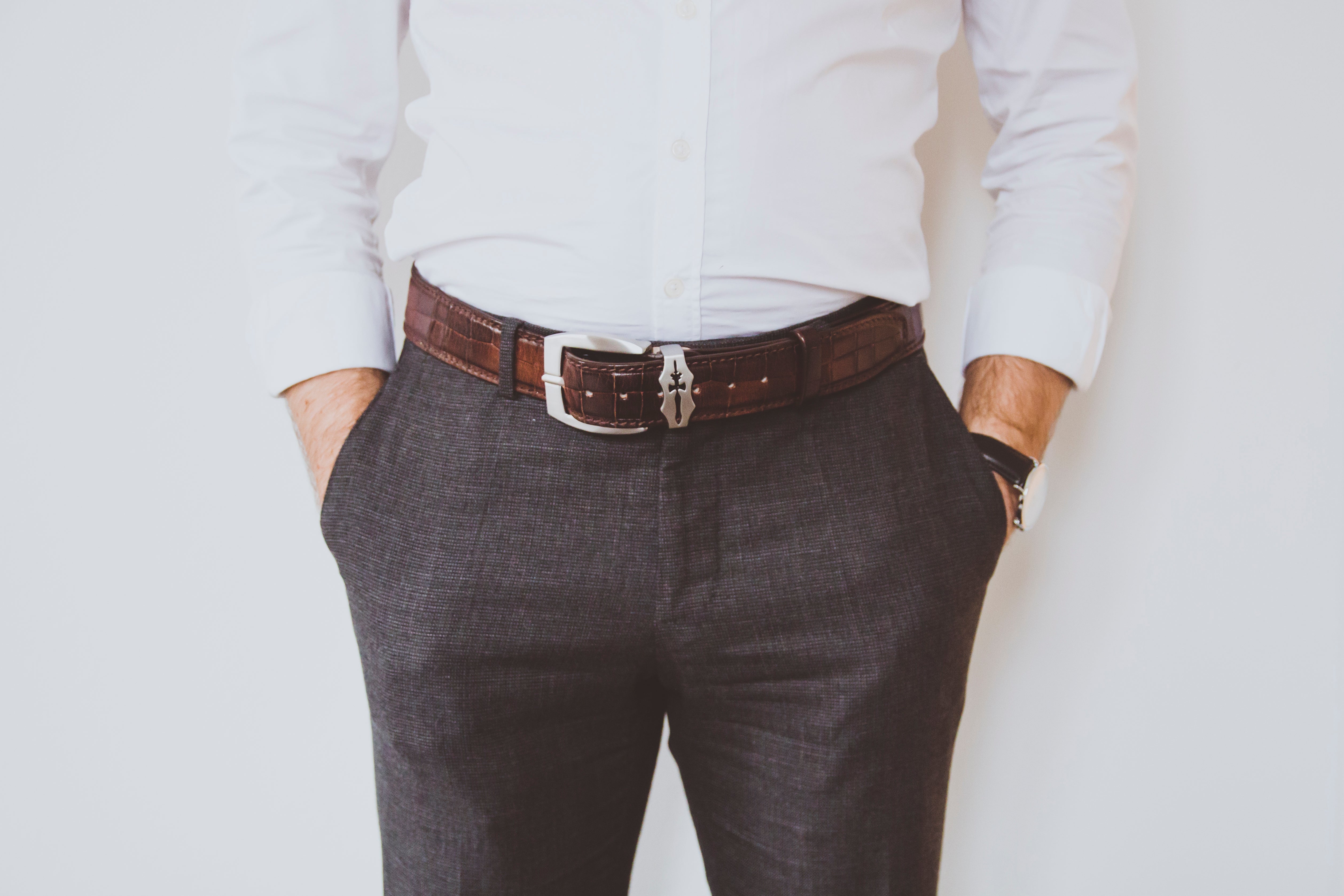 Classic suit belt and trousers of a man with his hands in the pockets Stock  Photo - Alamy